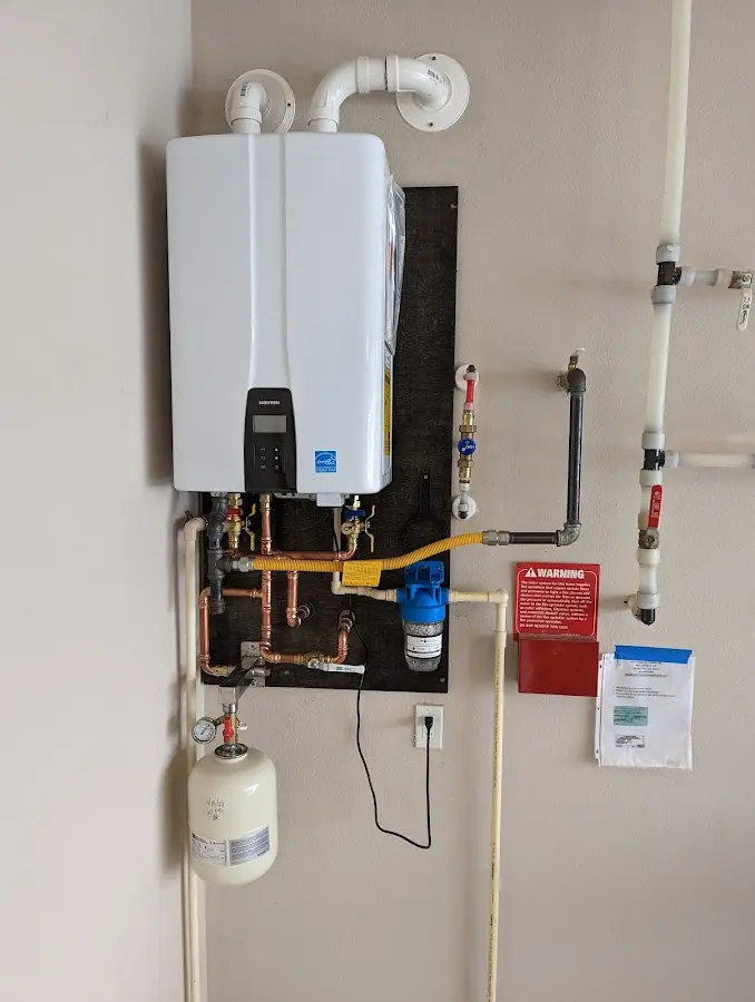 Professional plumber installing copper piping in a Walnut home